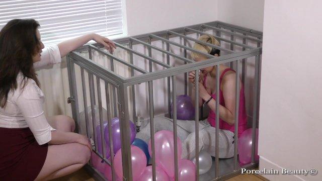 Caged Slave Girl Blows Up Balloons